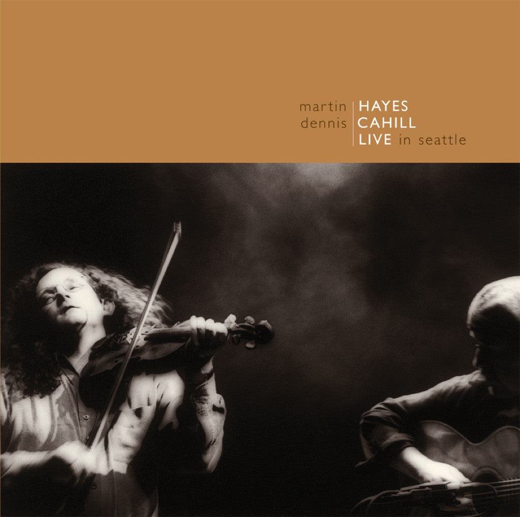 Black and white photo of a man playing fiddle and man playing guitar against a smokey backdrop. Above them is the title Martin Hayes and Dennis Cahill Live in Seattle
