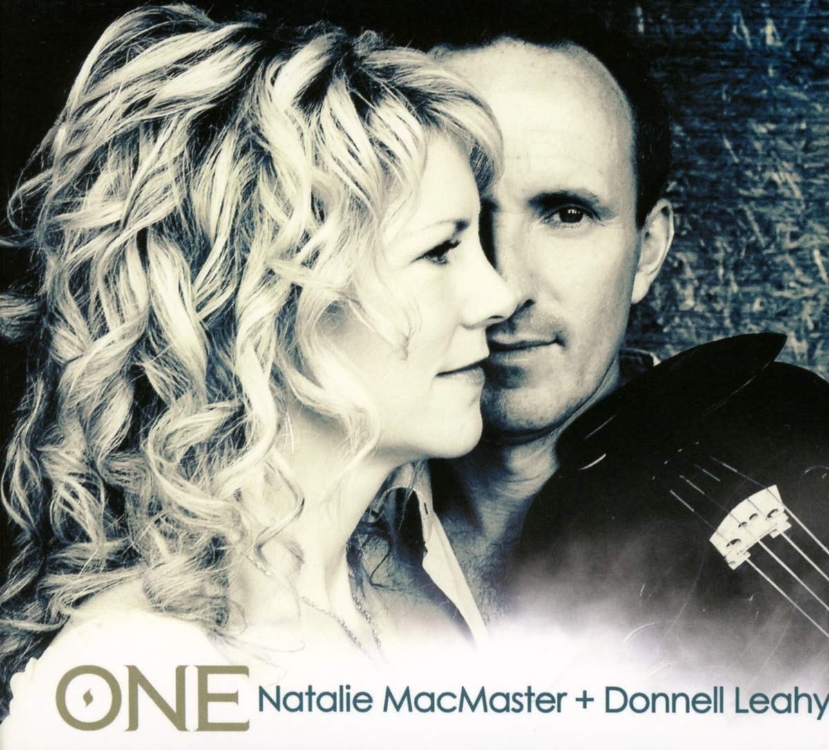 Black and white image of a man and woman with a guitar, featuring the text 'ONE Natalie MacMaster + Donnell Leahy'.