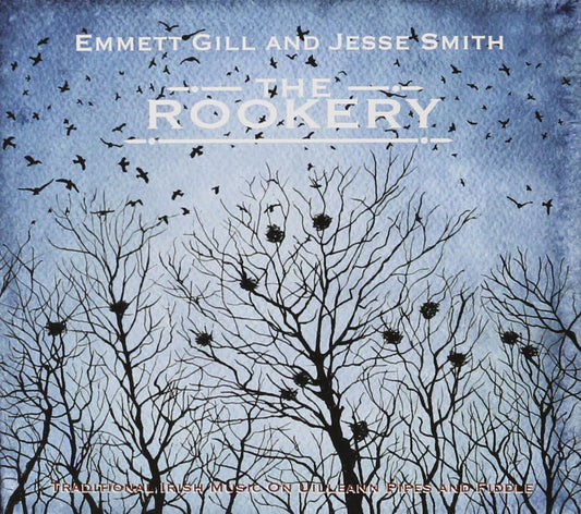 Crows fly in a dark sky over the silhouette of trees stripped of leaves