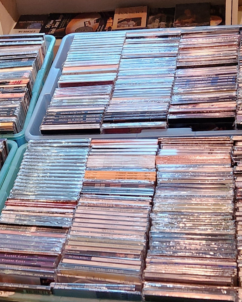 bins of CDs and books on a shelf