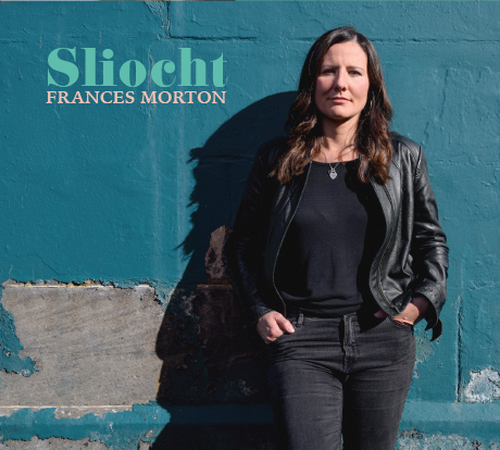 Person standing against a textured blue wall with 'Sliocht' and 'Frances Morton' text.