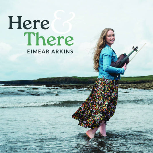 Eimear Arkins wades through the water with her fiddle