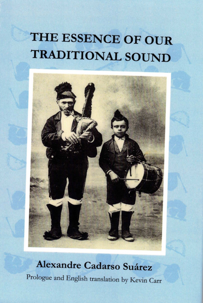 A spiral-bound book titled 'THE ESSENCE OF OUR TRADITIONAL SOUND' by Alexandre Cadarso Suárez, with a light blue cover and a vintage black-and-white photo of two men playing traditional instruments, photographed on a dark brown surface.