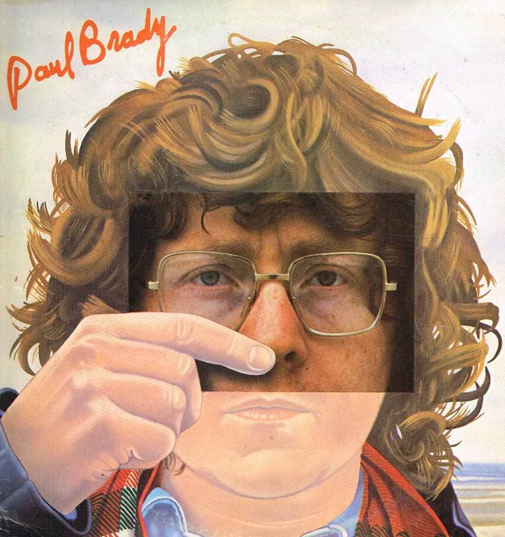Album cover with a person holding glasses, featuring the name 'Paul Brady'.