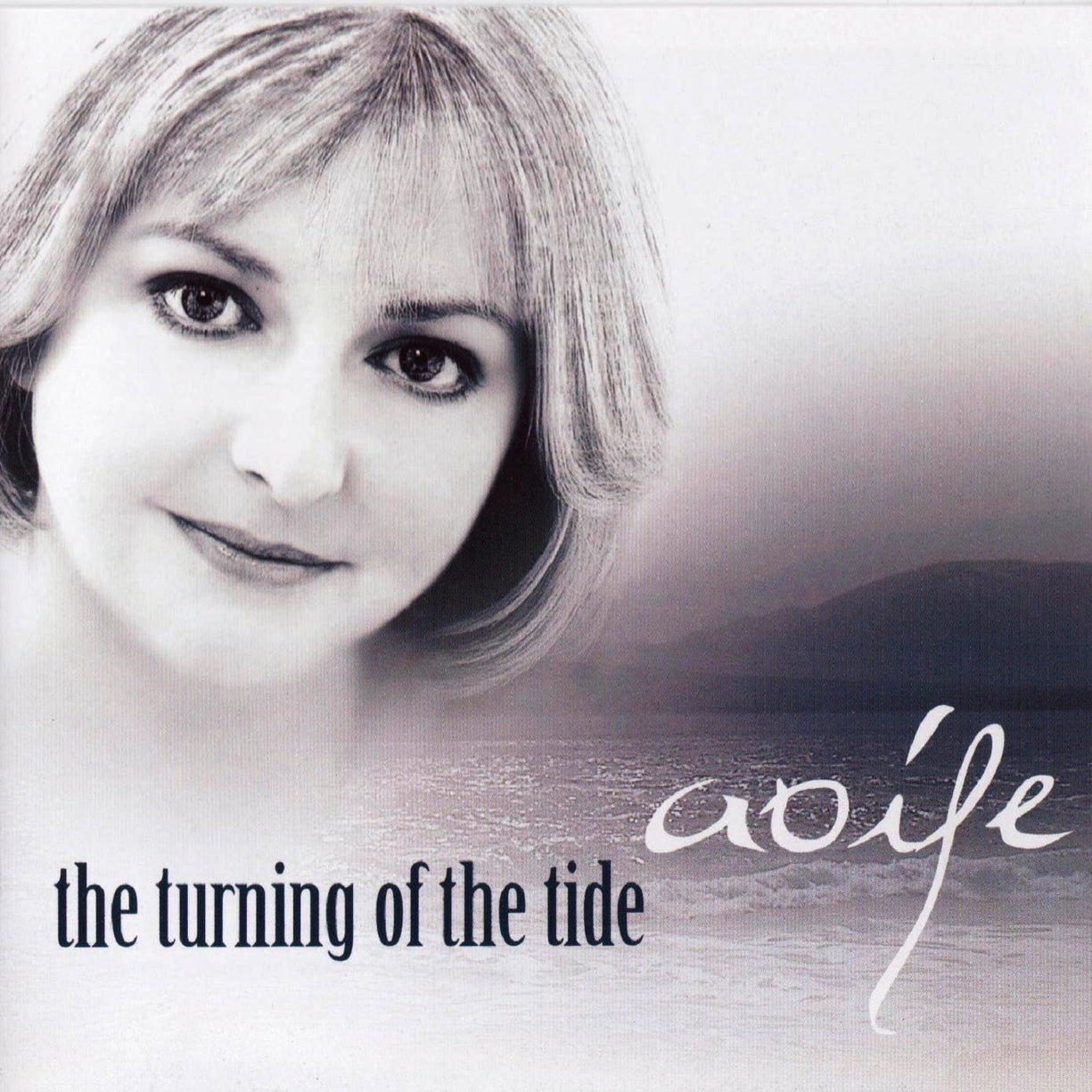 Album cover with a woman's face and 'the turning of the tide' text on a gradient background
