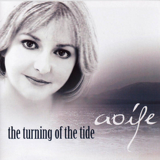 Album cover with a woman's face and 'the turning of the tide' text on a gradient background